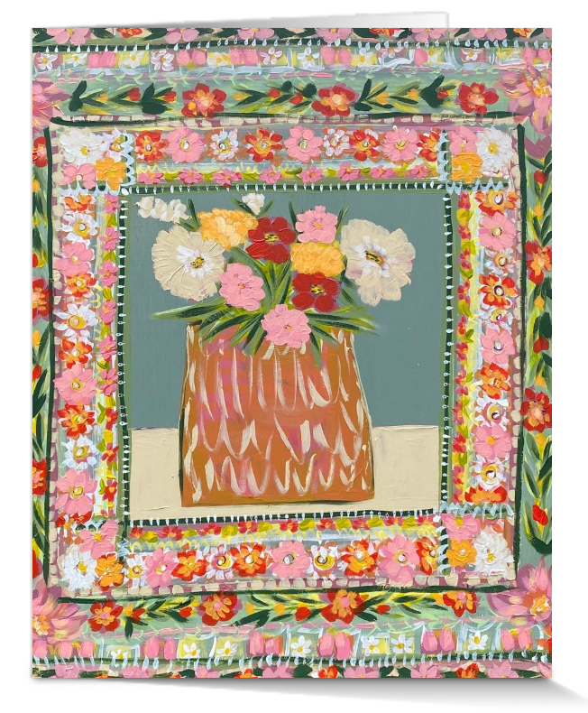 Decorative quilt with floral border and central vase of flowers