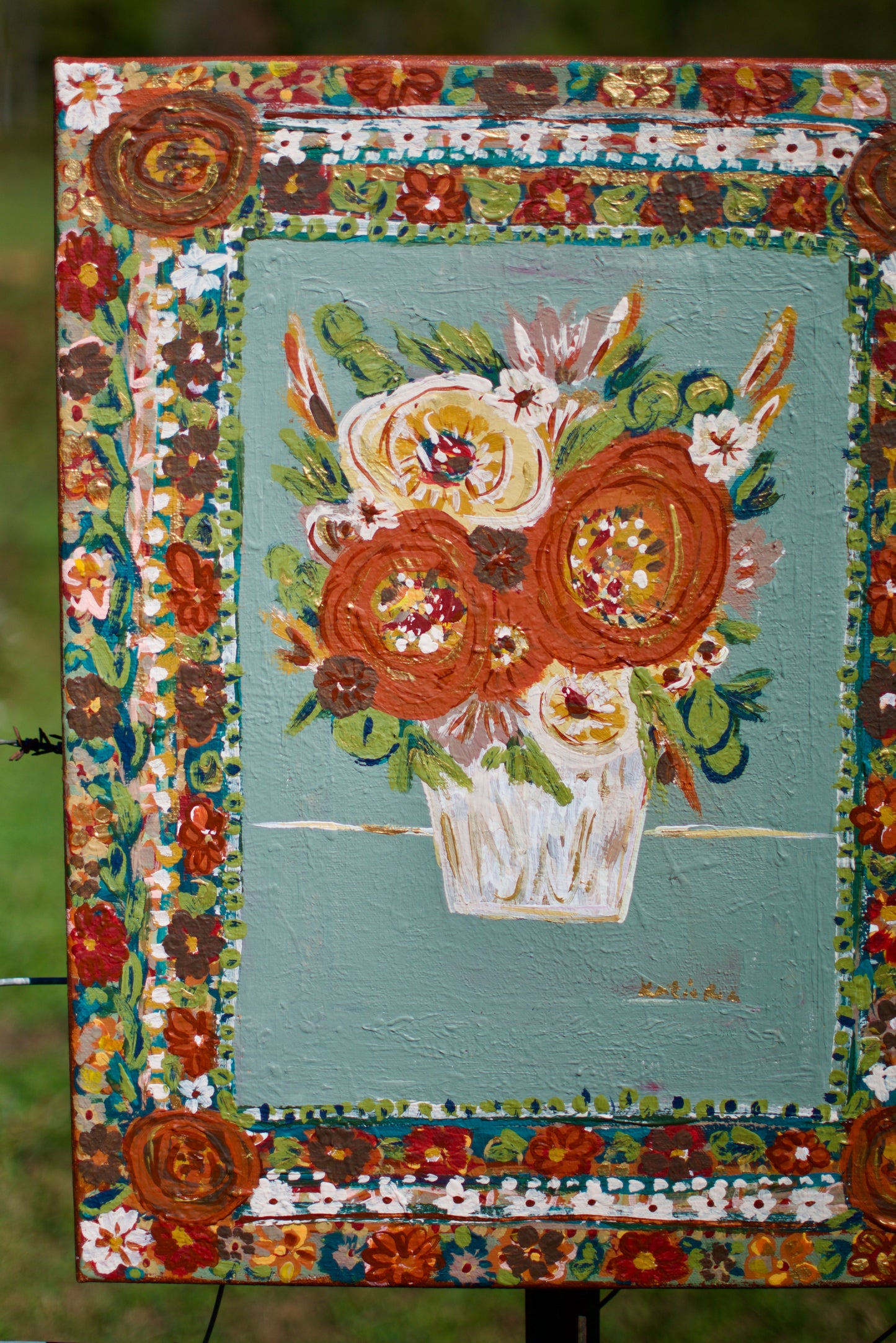 Decorative painting of an owl with flowers in a vase, framed by floral patterns.